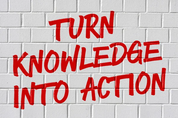 Graffiti on a brick wall - Turn knowledge into action — Stock Photo, Image