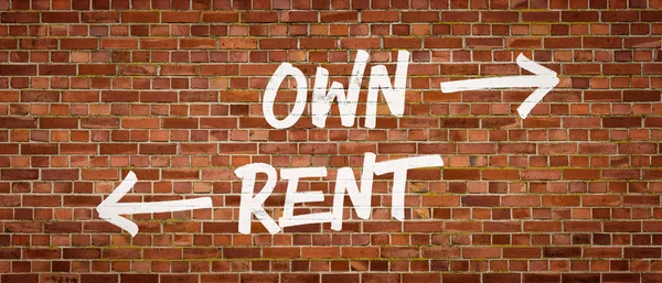 Own or Rent written on a brick wall — Stock Photo, Image