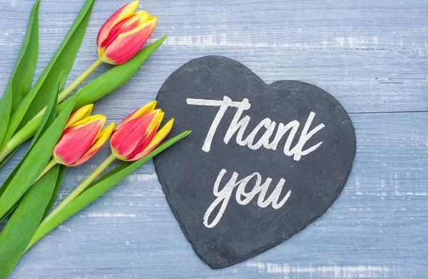 Thank you written on a heart-shaped sign — Stock Photo, Image