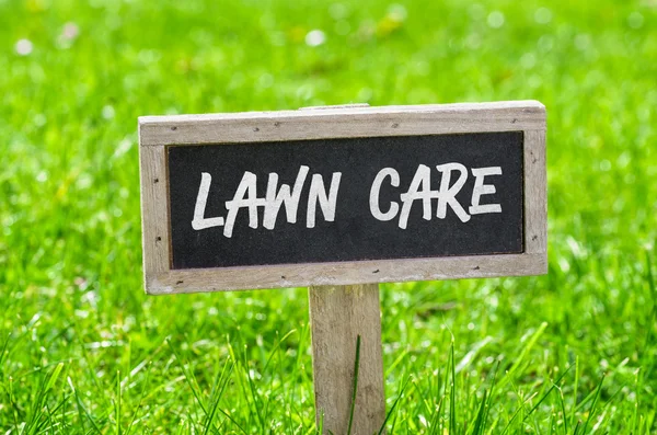 Sign on a green lawn - Lawn care — Stock Photo, Image