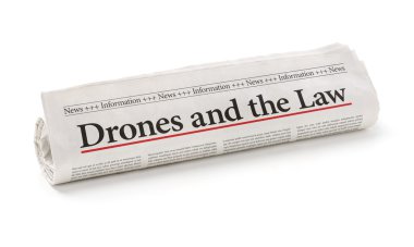 Rolled newspaper with the headline Drones and the Law clipart