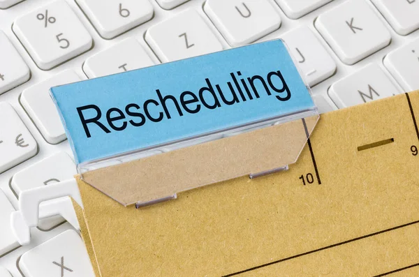 Brown File Folder Labeled Rescheduling — Stock Photo, Image