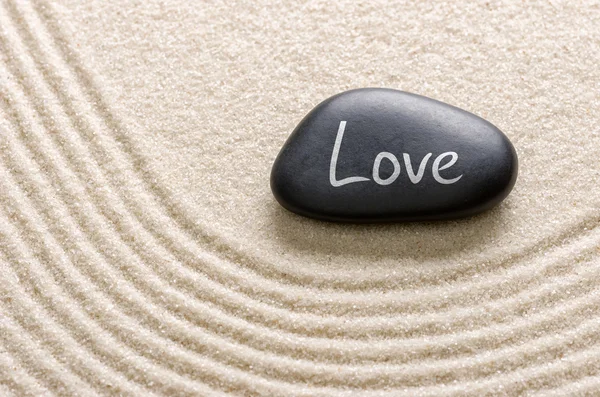 Black stone with the inscription Love — Stock Photo, Image