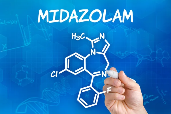 Hand with pen drawing the chemical formula of Midazolam — Stock Photo, Image