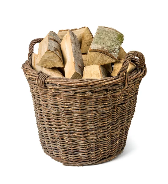 Wicker basket filled with firewood — Stock Photo, Image