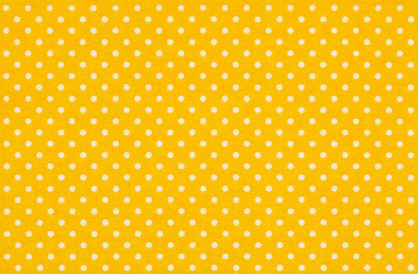 Gelber Stoff mit weißen Tupfen — Stockfoto