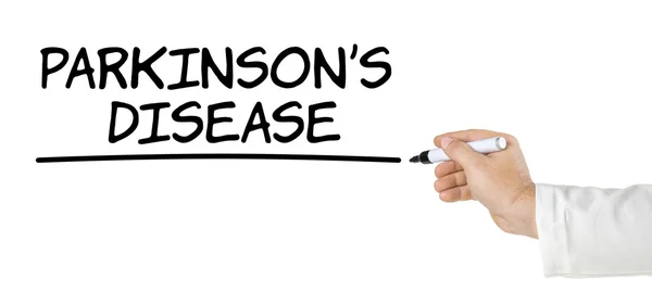 Hand with pen writing Parkinsons Disease — Stock Photo, Image