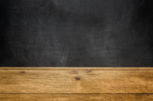 Background with wooden table and blackboard — Stock Photo, Image