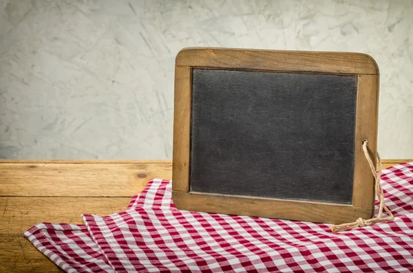 Old blackboard in a rustic setting — Stock Photo, Image