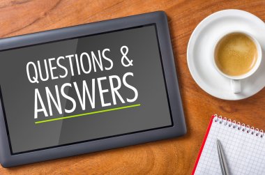 Tablet on a desk - Questions and Answers clipart