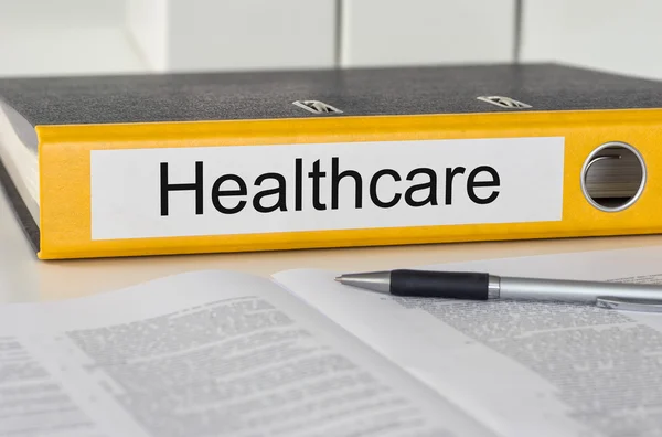 Folder with the label Healthcare — Stock Photo, Image