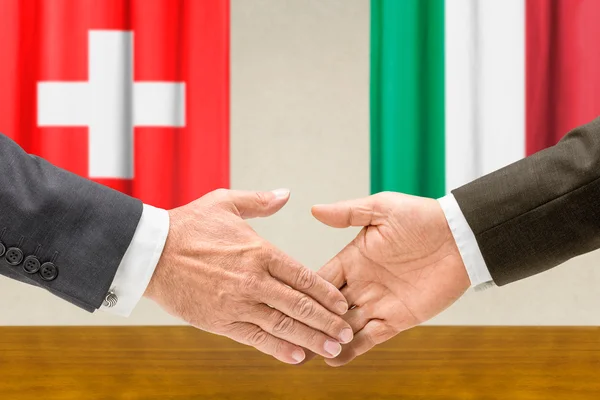 Representatives of Switzerland and Italy shake hands — Stock Photo, Image