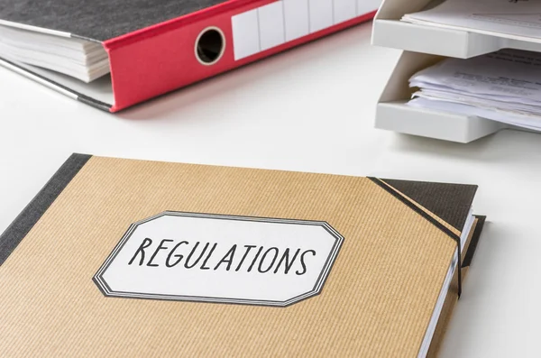 A folder with the label Regulations — Stock Photo, Image