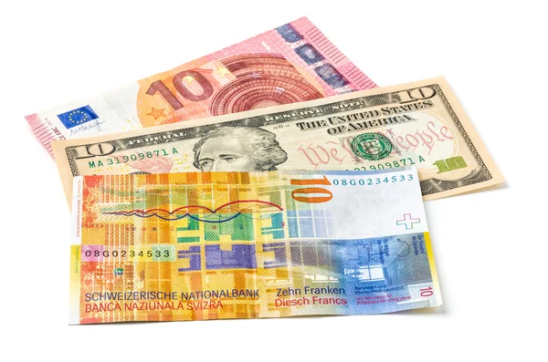 Євро, долар і швейцарські франки на білому фоні — стокове фото