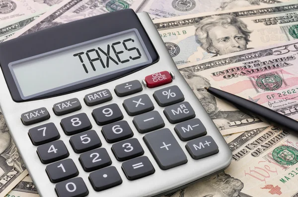 Calculator with money - Taxes — Stock Photo, Image