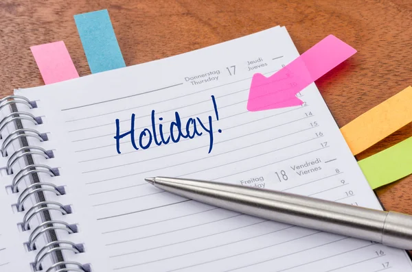 Daily planner with the entry Holiday — Stock Photo, Image