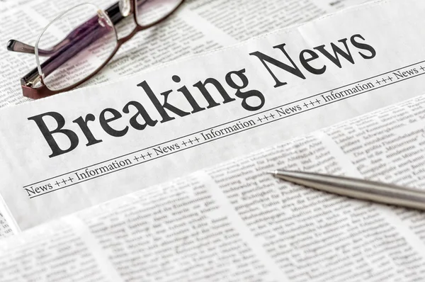 A newspaper with the headline Breaking News — Stock Photo, Image