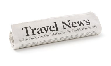 Rolled newspaper with the headline Travel News clipart