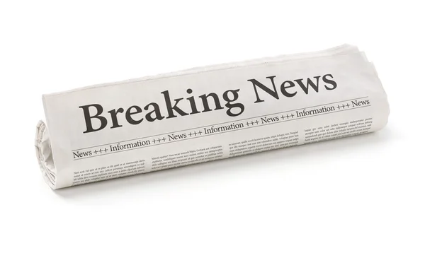 Rolled newspaper with the headline Breaking news — Stock Photo, Image