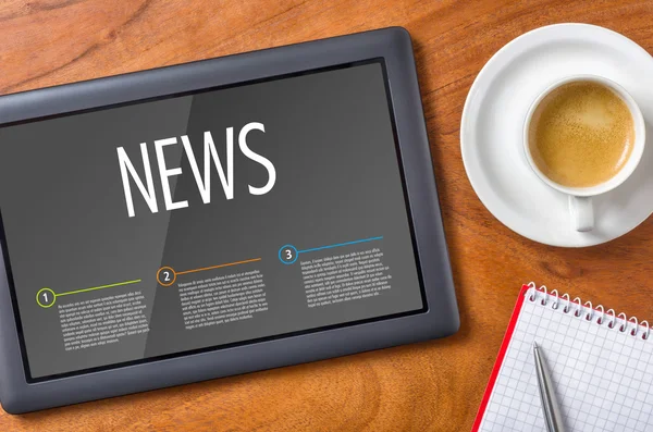 Tablet on a wooden desk - News — Stock Photo, Image