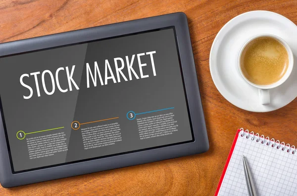 Tablet na dřevěný stůl - akciový trh — Stock fotografie