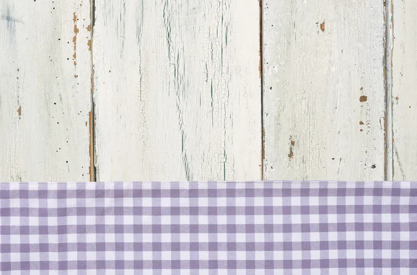 Violet checkered tablecloth on a white wooden background — Stock Photo, Image
