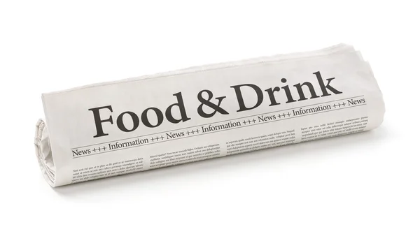 Rolled newspaper with the headline Food and Drink — Stock Photo, Image