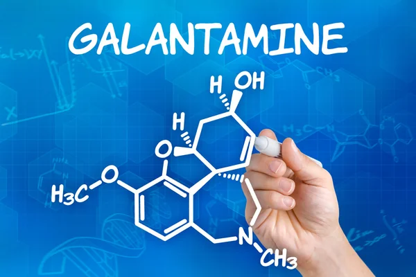 Hand with pen drawing the chemical formula of Galantamine — Stock Photo, Image