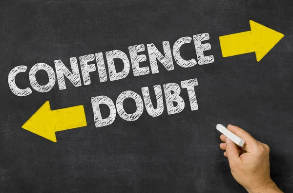 Confidence or Doubt written on a blackboard — Stock Photo, Image