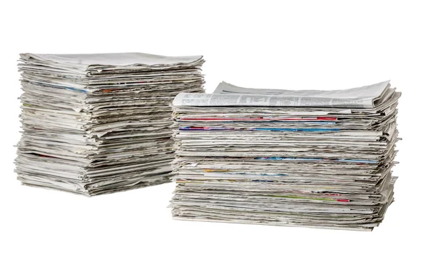 Two piles of newspapers on a white background — Stock Photo, Image