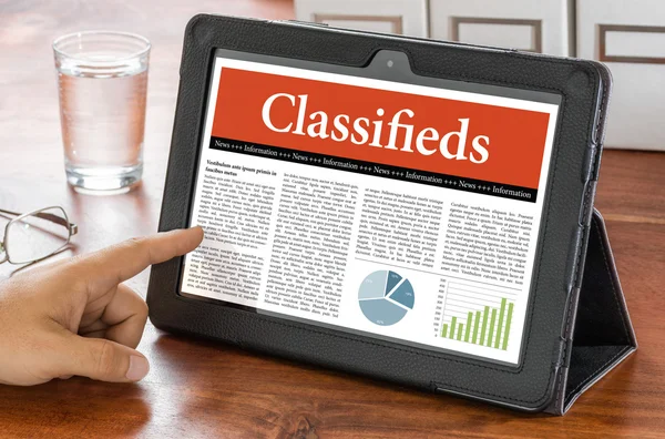 A tablet computer on a desk - Classifieds — Stock Photo, Image