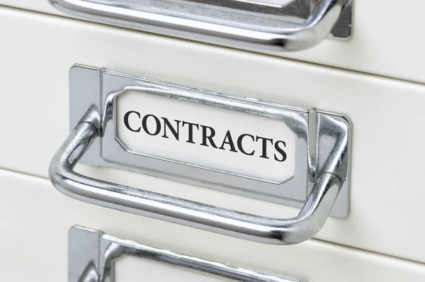A drawer cabinet with the label Contracts — Stock Photo, Image