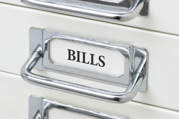 A drawer cabinet with the label Bills — Stock Photo, Image