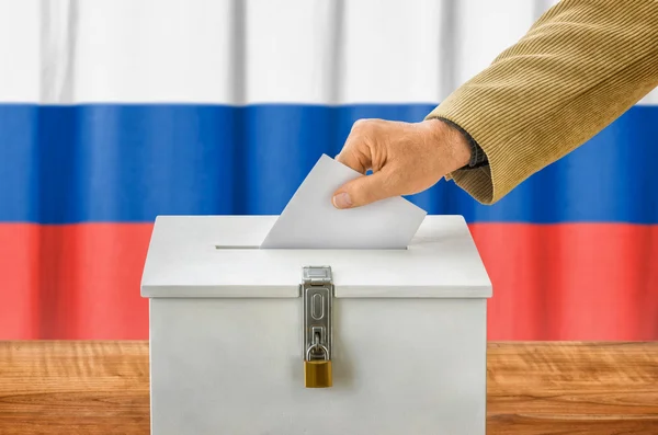 Uomo che mette una scheda elettorale in una casella di voto - Russia — Foto Stock