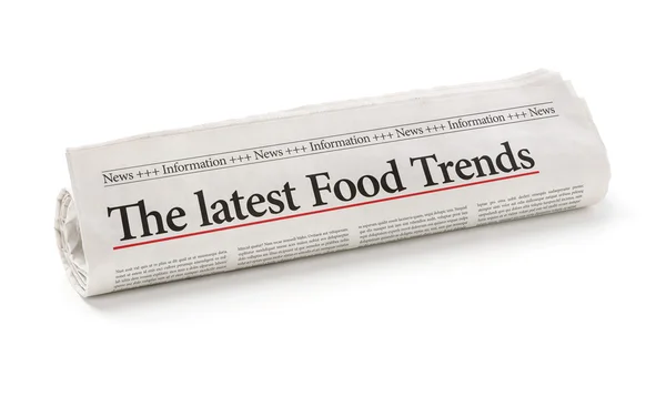 Rolled newspaper with the headline The latest Food Trends — Stock Photo, Image