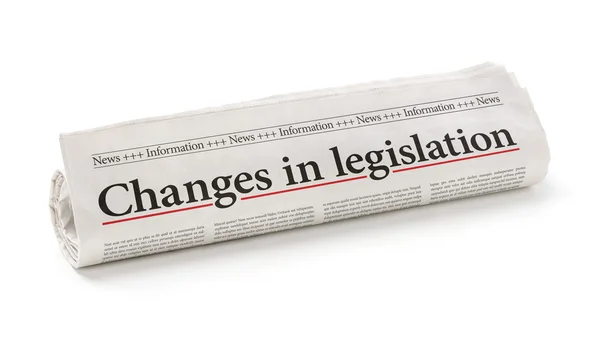 Rolled newspaper with the headline Changes in legislation — Stock Photo, Image