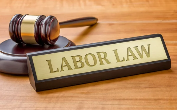 A gavel and a name plate with the engraving Labor Law — Stock Photo, Image