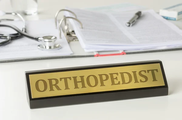 Nazwa płyty na biurku z Grawerowanie ortopeda — Zdjęcie stockowe