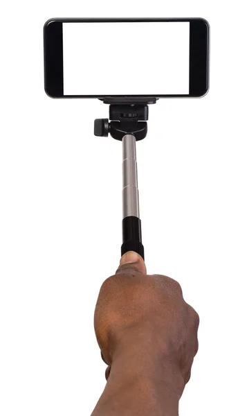 Hombre tomando selfie usando mano monópodo y un teléfono móvil — Foto de Stock