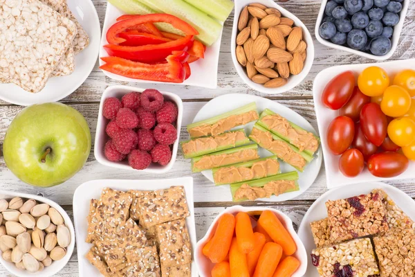 Healthy snacks on wooden table, top view — Stock Photo, Image