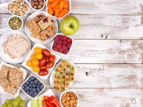 Healthy snacks on wooden table with copy space, top view — Stock Photo, Image