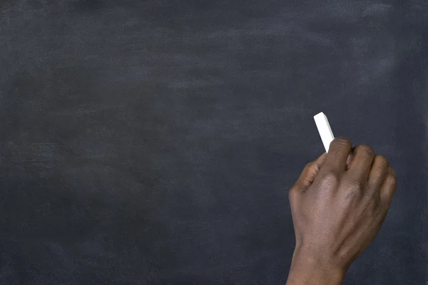 Man writing on a blackboard — Stock Photo, Image