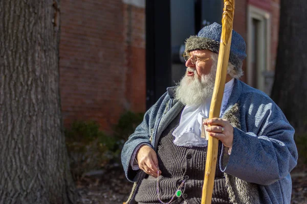 Saint Charles, MO--Dec 22, 2018; historic actor portraying Santa Clause in historic blue outfit with carved wooden cane