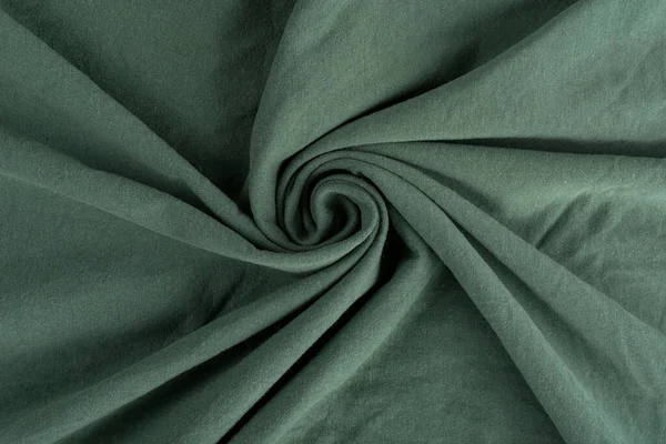 Crumpled linen cloth texture. Wrinkled textile. Green.