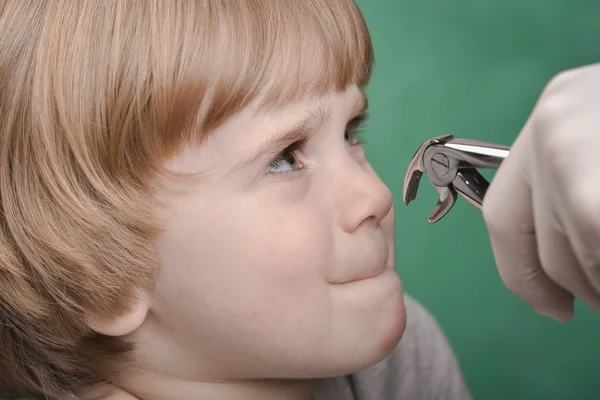 Small child and dental instrument — Stock Photo, Image