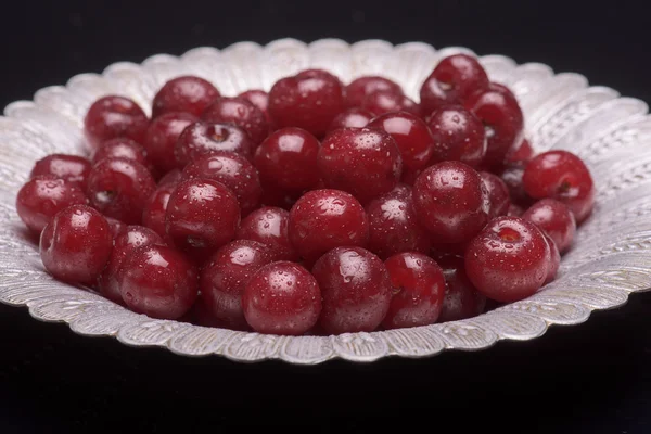 Sour cherry on a silver plate — Stock Photo, Image