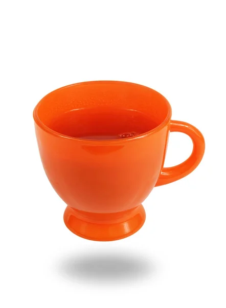 Апельсинова Скляна Чашка Повна Чаю Вирівнюється Над Білою Поверхнею — стокове фото