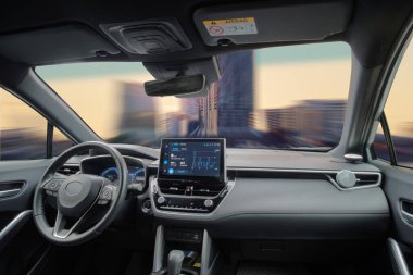A car interior driving fast in the city