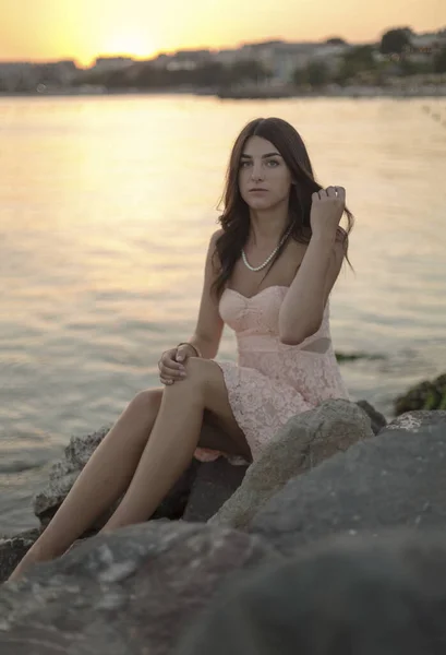 Young slim beautiful woman on sunset beach