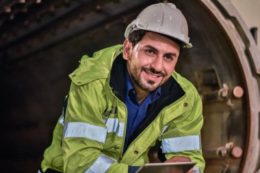 Worker Engineer use tablet work in factory engineering control in production process